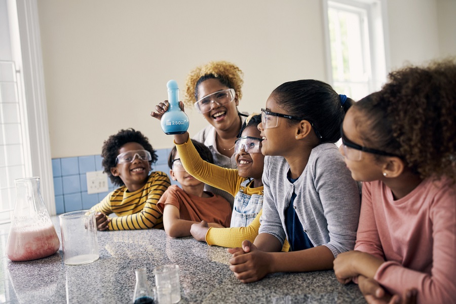 ,teacher smile and student experiment excited in a classroom 